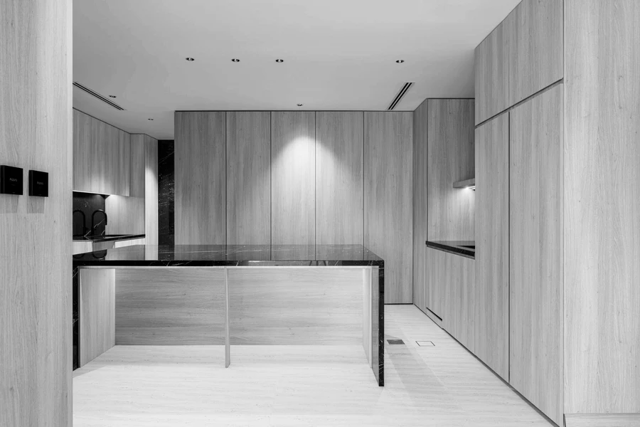 Minimal kitchen with an oak island and integrated lighting